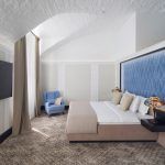 Why invest in professional hotel photography? This elegant bedroom shot by Kirill Toll showcases how proper lighting and composition can transform an ordinary room into an inviting luxury space.