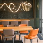 The original dining zone RAW file before editing, with harsh neon light contrast and color temperature shifts.