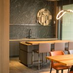 The original vertical kitchen RAW file before editing, with parasitic warm tints from the wood panels and line distortion.