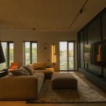 The original living room RAW file before editing, with mixed lighting, collapsing corner verticals, and an excessive yellow tint.