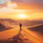 a lone figure standing at the edge of a vast desert landscape under a brilliant sunset, embodying the freedom and growth of nomadic living.