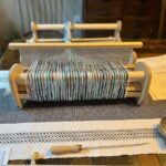 Warped loom on table with hook