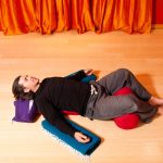 man in restorative yoga pose