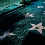 Night view of Hollywood Walk of Fame stars showcasing celebrity names and iconic design.