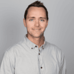 A headshot of a man in his 30s