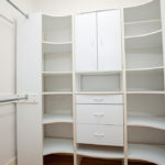 Walk-in closet at 3764 Alabama St in North Park featuring custom white built-in shelving, drawers, and cabinetry for ample storage and organization.