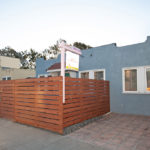 Blue stucco home at 3764 Alabama St in North Park featuring a modern horizontal wood slat fence and a "Coming Soon" real estate sign.
