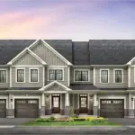 Architectural rendering of a multi-unit townhouse row at Empire Avalon featuring grey siding, stone accents, and gabled rooflines.