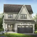 Two-story 33-foot detached house design at Empire Legacy featuring light horizontal siding, a prominent front gable, a double garage, and stone-wrapped porch pillars.