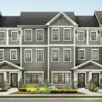 Architectural rendering of Empire Legacy rear lane townhomes featuring modern grey siding, stone accents, multiple gables, and second-story balconies.