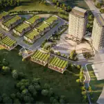 High-angle aerial rendering of the SXSW Ravine Towns community showing modern townhomes with green roofs, two high-rise residential towers, and a central landscaped plaza surrounded by lush forest.