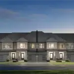 Architectural rendering of modern luxury townhomes at Mapleview Park featuring stone and brick facades, dark grey roofing, and integrated garages under a dusk sky.