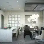 Modern open-concept kitchen and dining area at The Towns on Bayview, showcasing a large marble-waterfall island with bar stools, minimalist white cabinetry, a dark wood dining table, and contemporary bubble chandelier lighting.