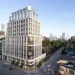 Exterior architectural rendering of The Bedford, a luxury multi-story residential building with a limestone facade and large windows, located on a prominent city corner with a view of the Toronto skyline.