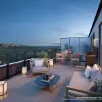 Private rooftop terrace of a Westshore Sky Townhome at dusk, furnished with a patio set and offering views of the CN Tower and Lake Ontario.