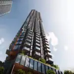 A dramatic low-angle worm's-eye view looking up at the Kipling Station Condos skyscraper, highlighting the glass balconies and modern architectural design against a bright sky.