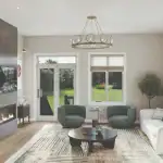Spacious open-concept great room at Arbor West featuring a floor-to-ceiling marble fireplace with an integrated TV, modern furniture, and large glass doors leading to a backyard green space.