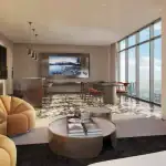 Modern indoor resident lounge at The Rebecca Condos featuring floor-to-ceiling windows, designer circular seating, a sleek kitchenette, and a large dining area perfect for social gatherings.