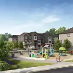 Community amenity park at The Nine development, featuring a modern children's playground with slides, sandpit, and seating areas surrounded by new townhomes.