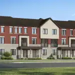 Row of Dual Front Townhomes at The Nine community, showcasing a mix of red brick and light stone exteriors with covered front entries and dark trim.