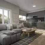 Interior rendering of an open-concept living room and kitchen at The Block on Clair, showcasing a grey sectional sofa, light wood flooring, and a modern kitchen with dark grey cabinetry and stainless steel appliances.