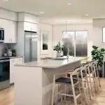 Modern open-concept kitchen and living area inside a residence at The Grove Townhomes at Wildflower, featuring white cabinetry, stainless steel appliances, a large island with seating, and a built-in home office desk.