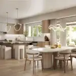 Modern open-concept kitchen and dining area at Triple Crown Estates by Greenpark Group, featuring light wood cabinetry, a marble-top island with seating, minimalist pendant lighting, and large sliding glass doors.