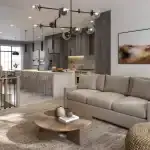 Open concept interior of a West Brooklin home showing a modern kitchen with a large island, stainless steel appliances, and a bright living room area.