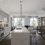 Luxury open-concept kitchen interior at Creekview Collective towns in Milton featuring a large marble waterfall island, pendant lighting, and professional-grade appliances.
