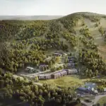 Aerial view of the luxury townhome development at Calabogie Peaks Resort, nestled in the lush green forests of the Ottawa Valley with ski hills in the background.
