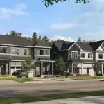 Modern two-storey townhomes for sale in Magnolia Stittsville, featuring charcoal grey siding, stone accents, and single-car garages in a landscaped Ottawa neighborhood.