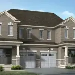 Modern semi-detached homes at Woodstone Trails, Dundalk, showcasing a coordinated grey brick and stone exterior with covered entryways and individual single-car garages.