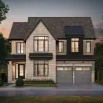 Modern two-story luxury home at The Legacy Millcroft, featuring a light grey brick exterior, black window frames, a double-car garage, and a peaked roofline.