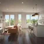 Bright open-concept kitchen at Time in Ajax featuring white cabinetry, stainless steel appliances, a large island with seating, and views of the living area and outdoor greenery.