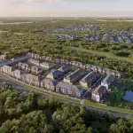 Aerial rendering of The Enclave by Cachet townhouse community, showcasing rows of modern townhomes nestled within a dense green forest landscape and adjacent to a small pond.