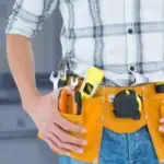 Common handyman homeowners need fixing a kitchen cabinet in a modern home.