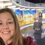 Woman smiling in television studio setting with "HOUSTONES morning show" backdrop and professional lighting, showcasing a vibrant and dynamic media environment for health, wellness, and lifestyle content focus.