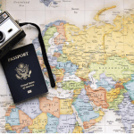 United States Passport and a vintage camera on a world map
