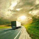 Commercial Trucking Services at Sunset A semi-truck driving on a highway at sunset, representing reliable trucking services and back-office support for your commercial trucking business.