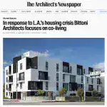 Contemporary multi-family residential building with geometric forms, black and white contrasting facades, and spacious balconies.