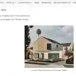 Contemporary two-story residence with a minimalist design, combining natural wood and white stucco materials, featuring angular rooflines and large windows.