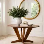 Intersection Round Dining Table. Made from Black Walnut with it’s straight lines and angles give it a dynamic solid look for the base. Versatile enough for use as a foyer round or bar table. Custom made timber furniture. Custom made furniture and furniture maker. Set in a home in Turramurra in the front hall.