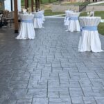 Outdoor covered patio with round cocktail tables set with white linens at Romaine Valley Weddings & Events
