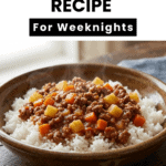 Close-up vertical shot of a bowlof savory Ground Beef Picadillo from a bowl of rice, with text at the top reading "Mexican Picadillo."