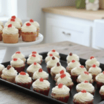 plate with a stack of three jelly bean cupcakes, surrounded by a small bowl of colorful jelly beans.