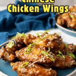 Overhead view of chicken wings on a wire rack being brushed with a thick, dark brown sticky sauce.