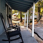Relaxing porch with rocking chairs in Eureka Springs, Arkansas, fall scenery.