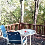 Relaxing outdoor deck with hot tub and forest view in Eureka Springs, Arkansas.