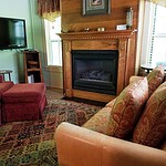 Cozy living room with fireplace, vintage furniture, and flat-screen TV in Eureka Springs.