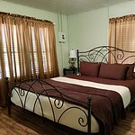 Cozy bedroom with vintage iron bed and natural light in Eureka Springs, Arkansas.